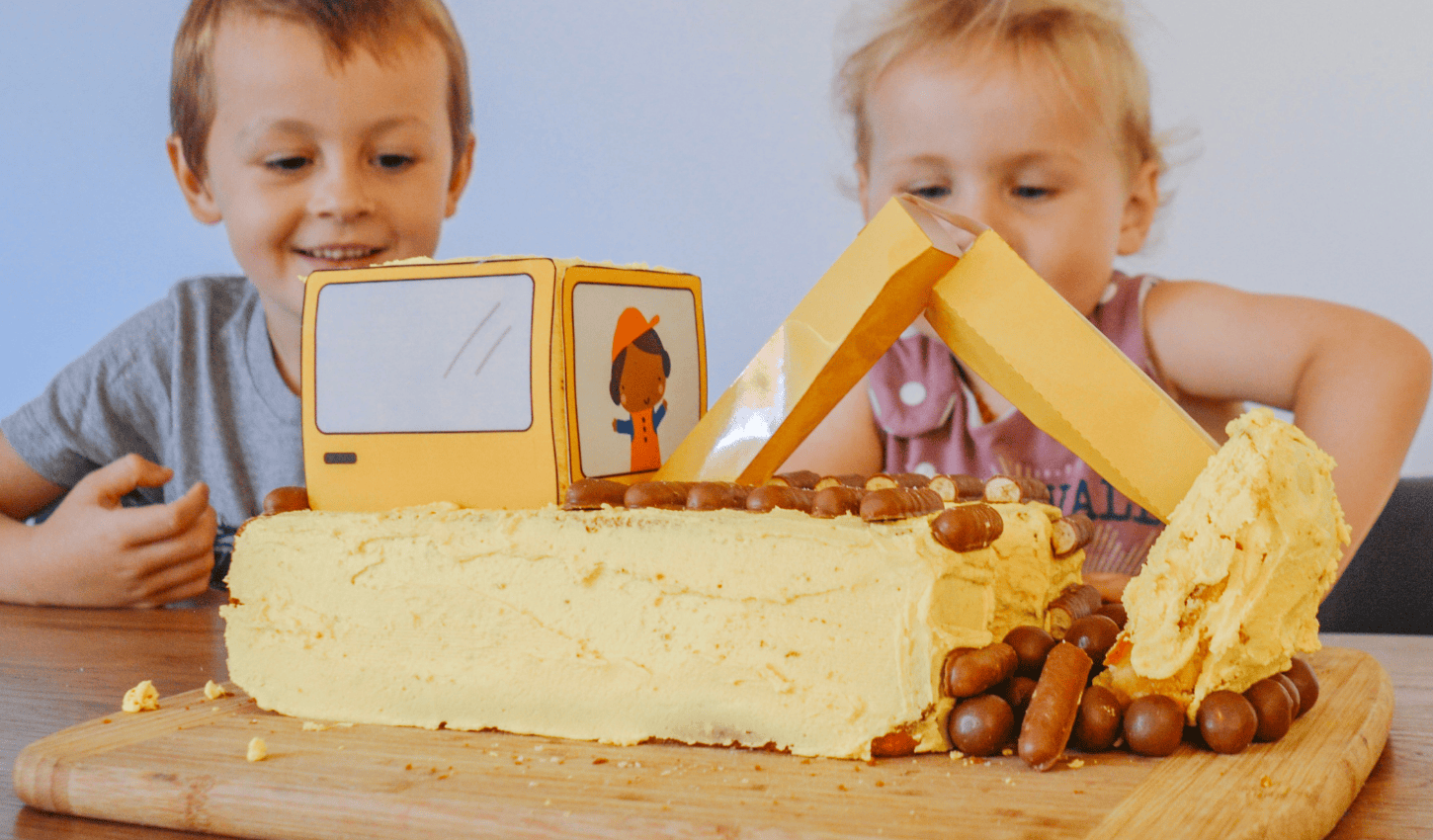 Kids enjoying a Shape Tins 3D Digger Birthday Cake